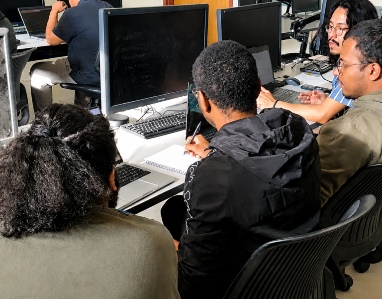 Three students working in a CS class
